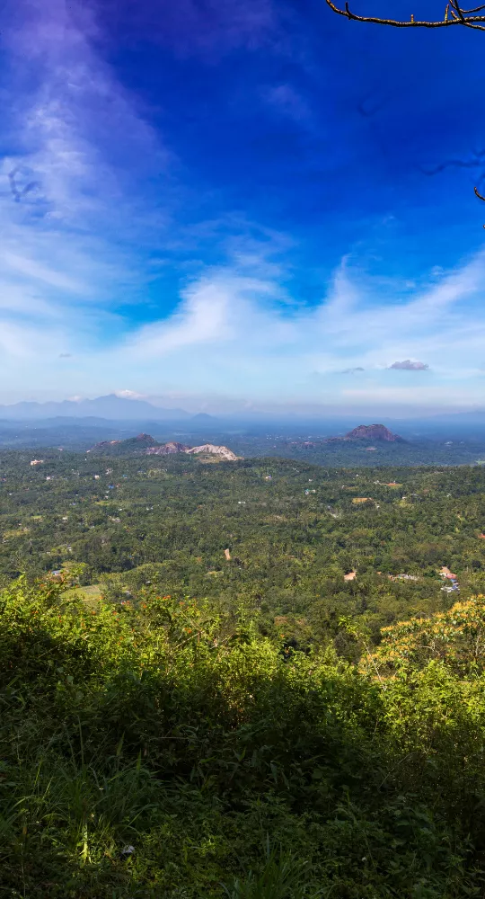 Expansive green valley under blue sky